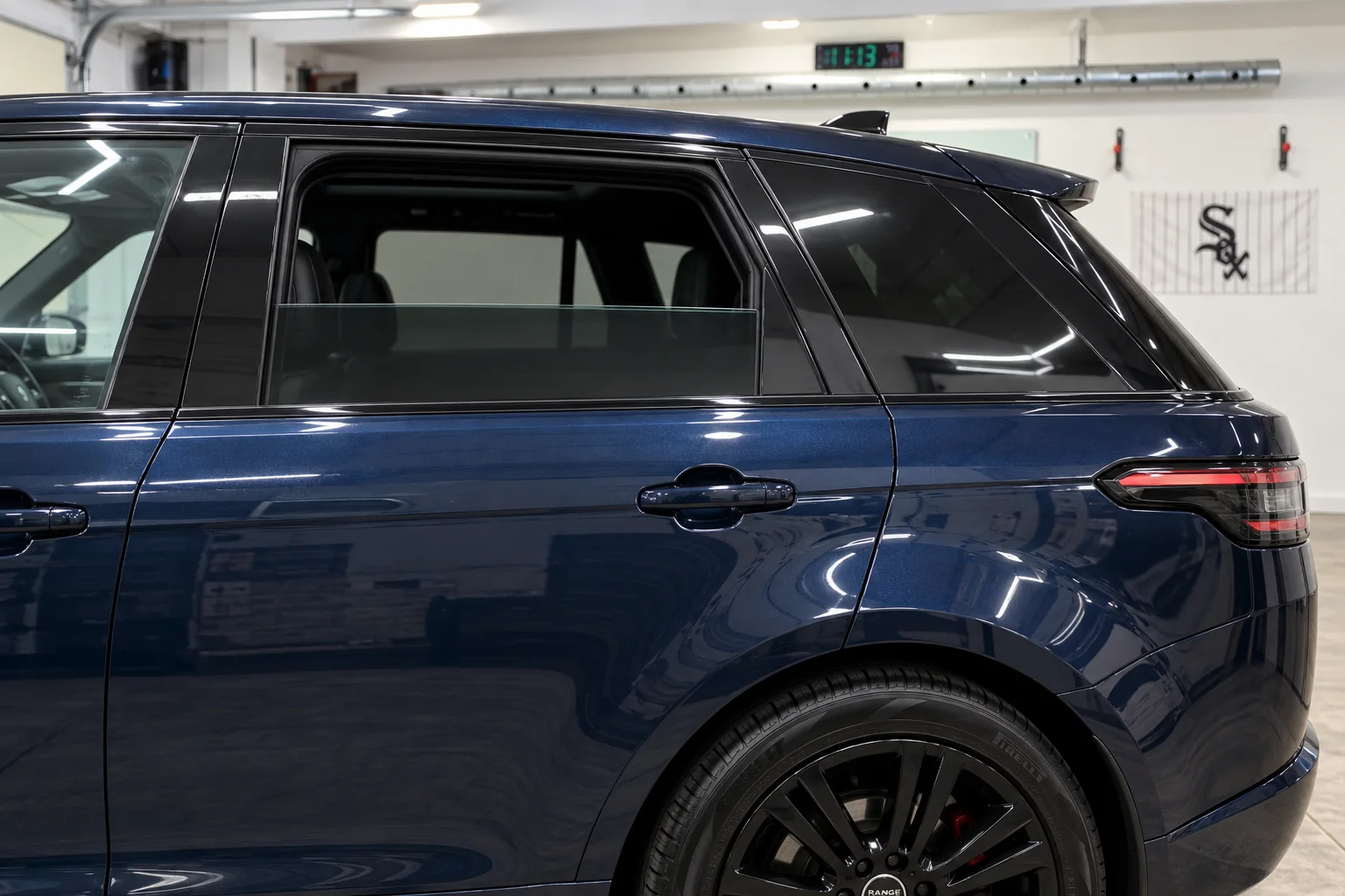 Deep navy blue metallic Range Rover Sport with tinted windows at Beast Auto Tints