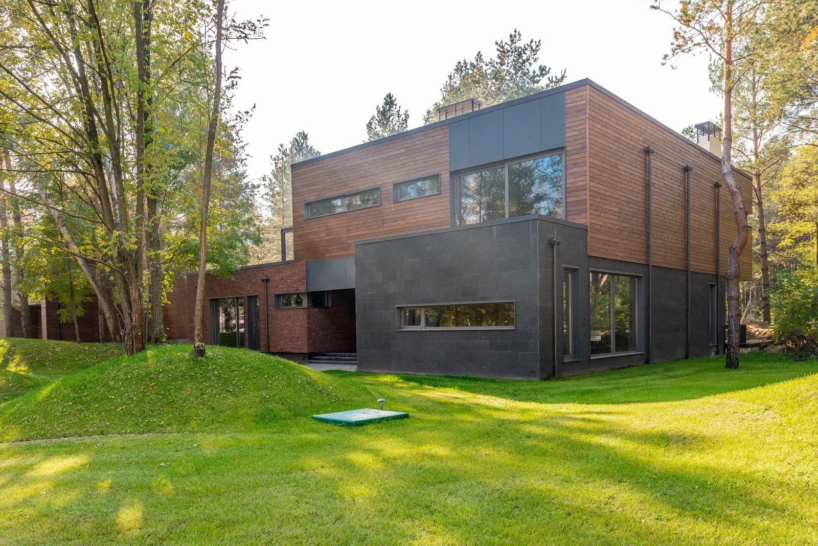 Modern house with large windows among trees