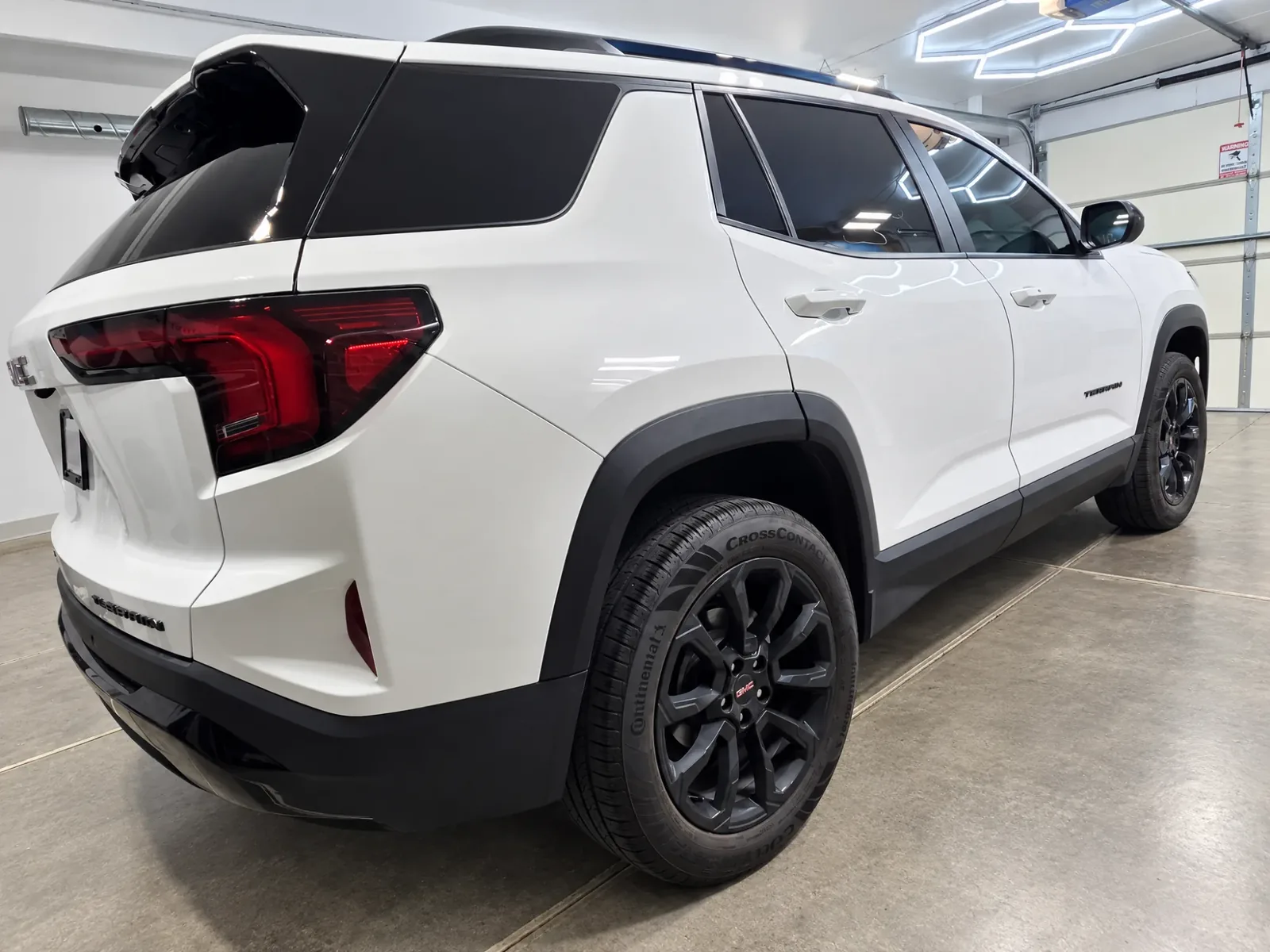 White GMC Acadia with tinted windows, tinted by Beast Auto Tints