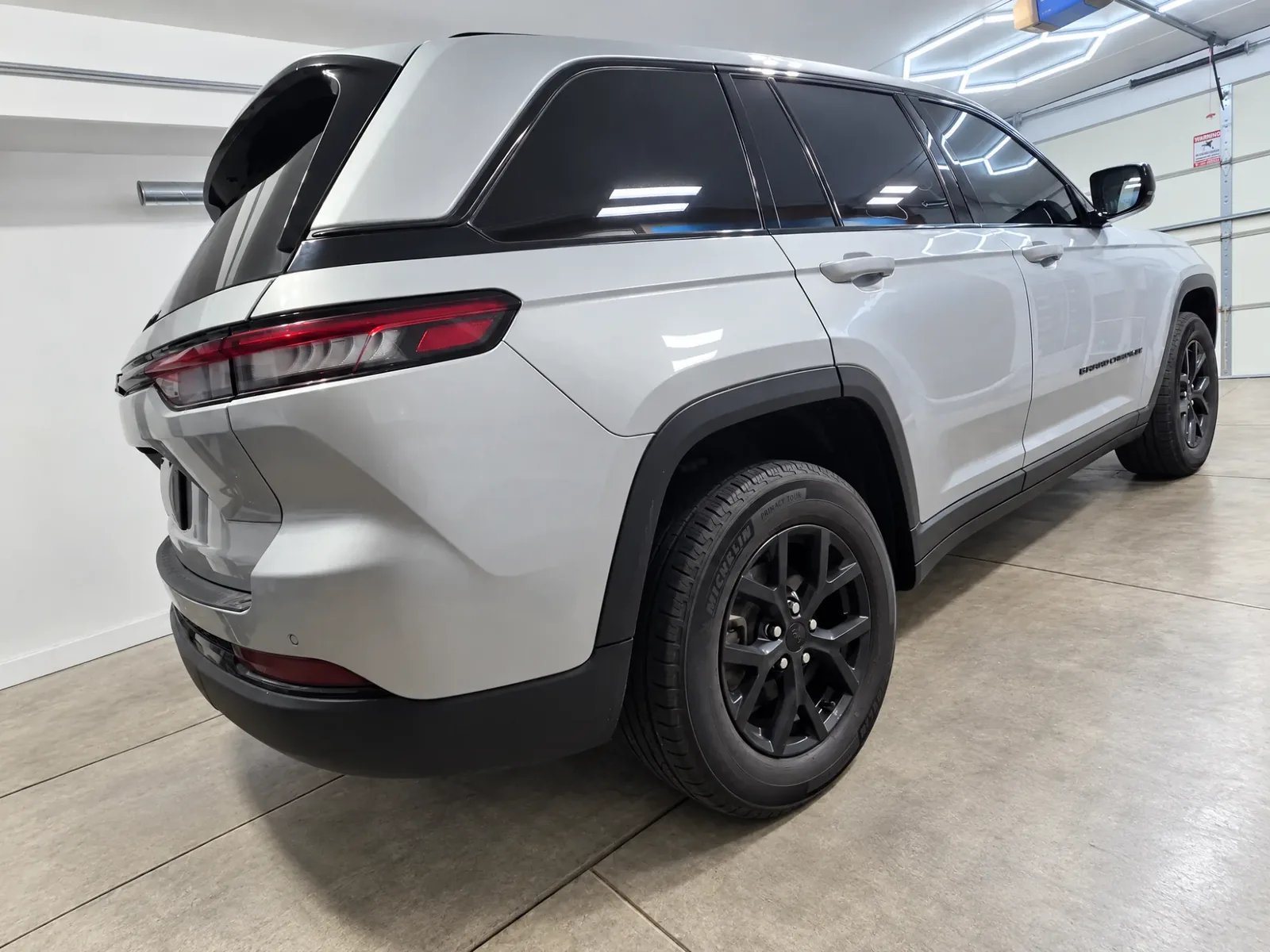 Silver Jeep Grand Cherokee with tinted windows, tinted by Beast Auto Tints